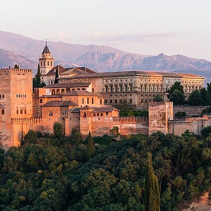 The Alhambra, a red stone hilltop fortress-palace in Spain.