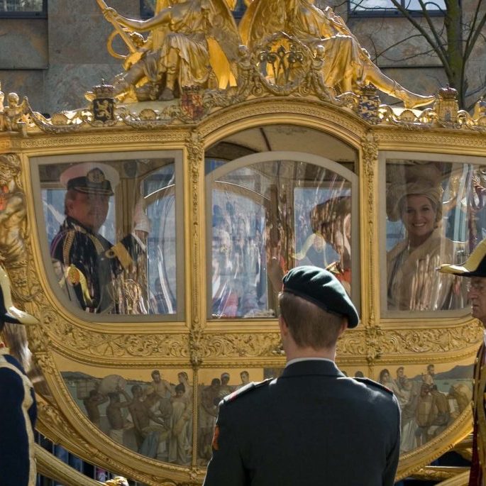 image of the Golden Coach with royalty inside - By Toni - originally posted to Flickr as the dutch royal family loves me!, CC BY 2.0, https://commons.wikimedia.org/w/index.php?curid=6512699