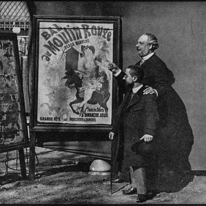 Henri de Toulouse-Lautrec standing with poster designer Jules Chéret with one of his posters for the Moulin Rouge.