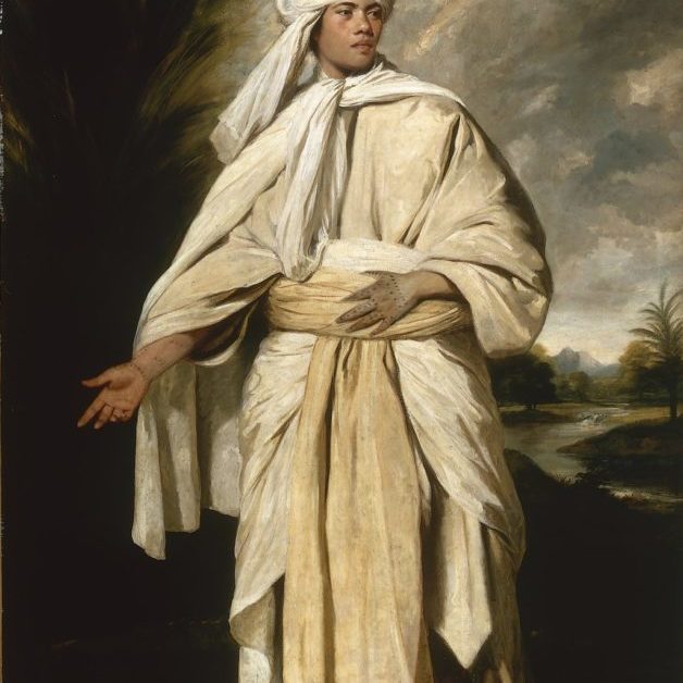 A portrait of a tan-skinned man in billowing white robes and a turban.