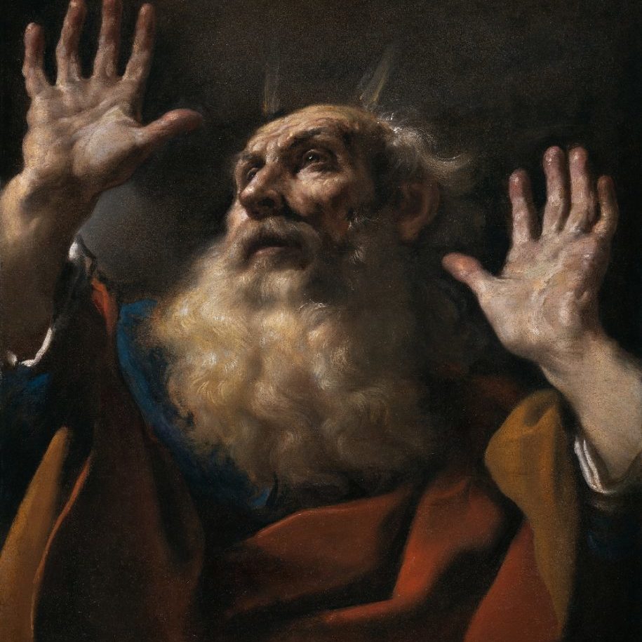 A portrait of an old, bearded man looking to the sky with his hands raised.