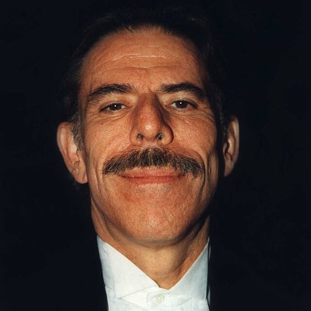 A photograph of the artist Peter Max