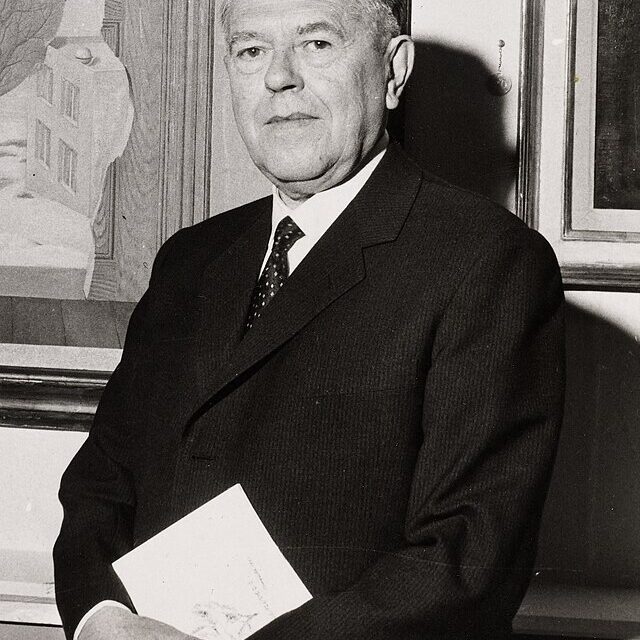 A photograph of René Magritte, an older man in a suit