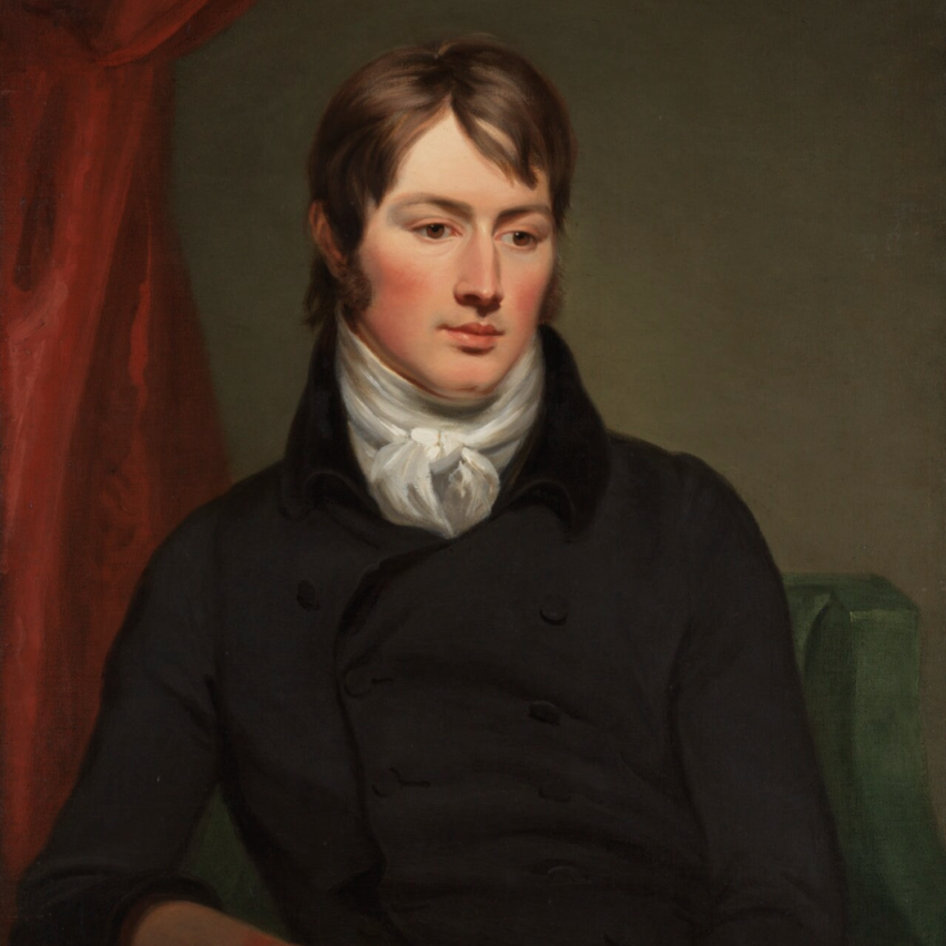 A portrait of the painter John Constable in a black suit with a white shirt sitting in a chair against red drapes