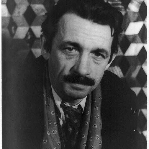 A black-and-white photograph of the painter Thomas Hart Benton, a middle-aged man with a thick moustache.