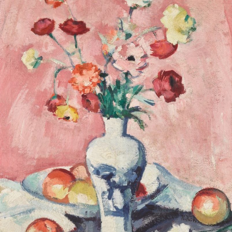 flowers in a vase with fruit on a table