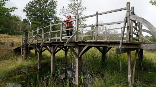 A person standing on a bridgeDescription automatically generated with low confidence