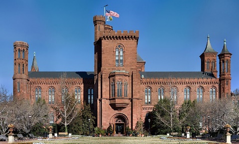 A large brick building with a flag on topDescription automatically generated with medium confidence