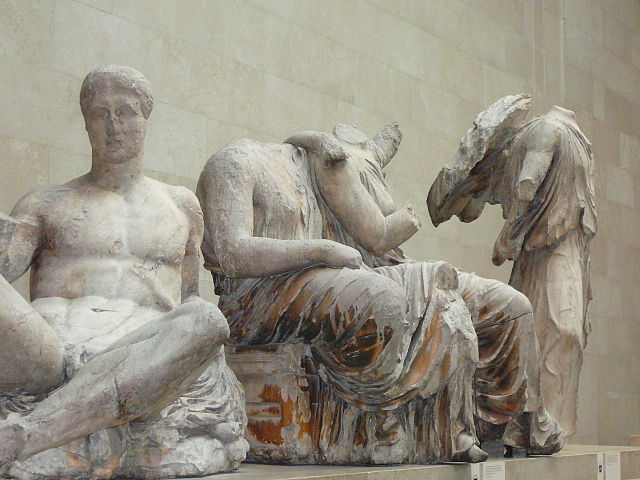 three marble sculptures of people