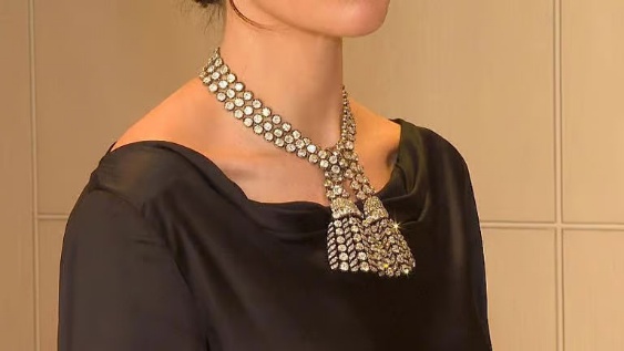 A person wearing a necklaceDescription automatically generated