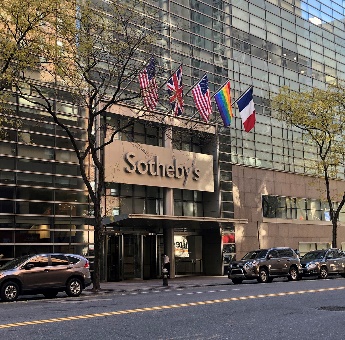 A building with flags on the frontDescription automatically generated