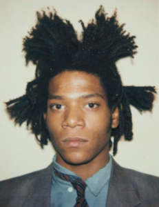 A portrait photograph of Jean-Michel Basquiat