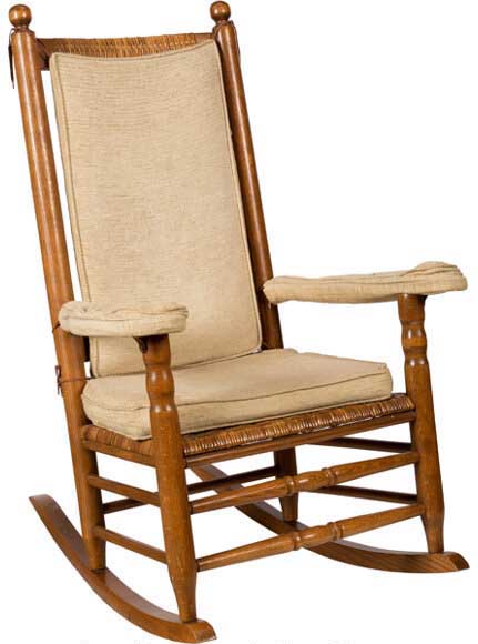 A wooden chair with a cushionDescription automatically generated with low confidence